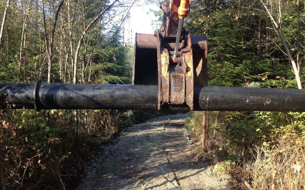 drainage pipe lifted by an excavator