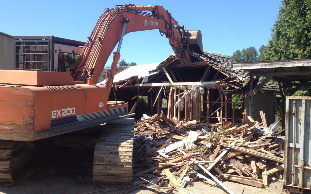 ex200 excavator demo on an old house