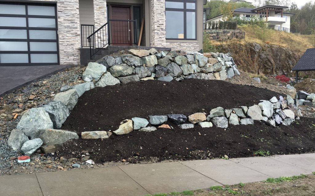 landscaped rock wall at front of house